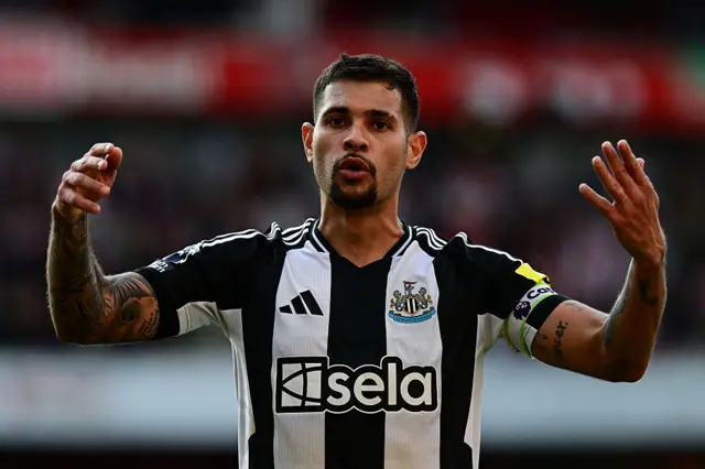 Bruno Guimareas with his arms in the air