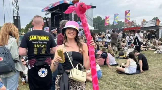 Alex Nelmes holding a pink giraffe toy