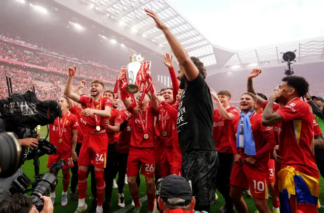 Liverpool's Andrew Robertson with the Premier League trophy after the Premier League match at Anfield, Liverpool.