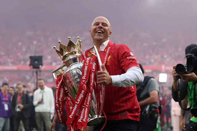 Arne Slot, Manger of Liverpool, celebrates with the Premier League trophy trophy, as Liverpool are crowned the Champions of the Premier League for the 2024/25 Season, following the Premier League match between Liverpool FC and Crystal Palace FC at Anfield on May 25, 2025 in Liverpool.