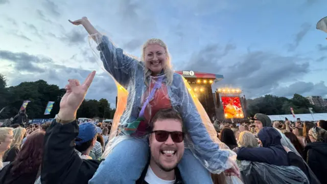 Kurtis holds Kerry up on his shoulders in the crowd