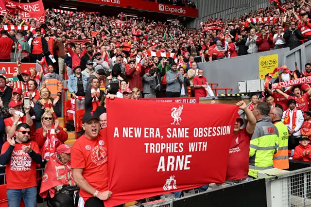 Fans of Liverpool display a banner which reads "A new era, same obsession, trophies with Arne"