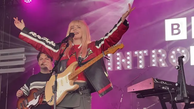 Pixey holds her arms up and smiles at the crowd at the BBC Introducing stage