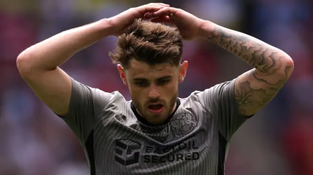 Charlie Kelman of Leyton Orient reacts, after hitting the bar with a shot