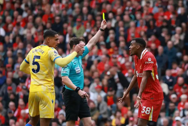 Liverpool's Ryan Gravenberch is shown a yellow card