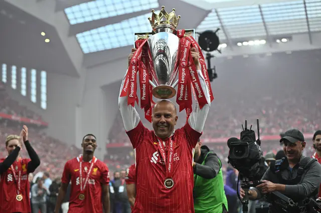 Arne Slot, the manager of Liverpool F.C. celebrates with the trophy after the Premier League match between Liverpool FC and Crystal Palace FC at Anfield on May 25, 2025 in Liverpool, England.