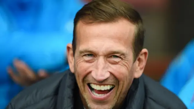 A smiling former Leyton Orient boss Justin Edinburgh