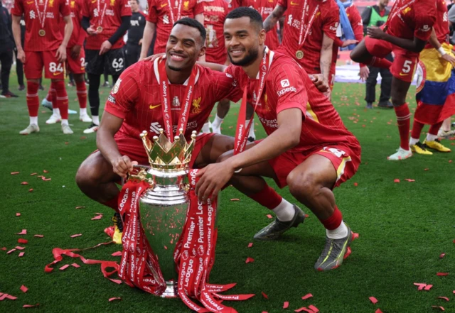 Liverpool's Ryan Gravenberch and Cody Gakpo celebrate with the trophy