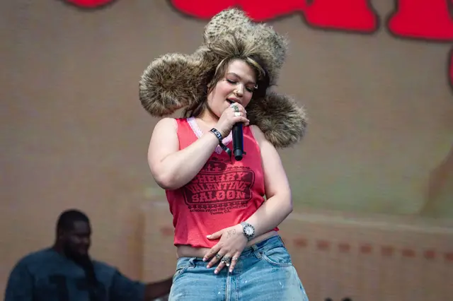 Lola Young performing on stage