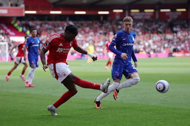 Anthony Elanga of Nottingham Forest crosses the ball whilst under pressure from Cole Palmer