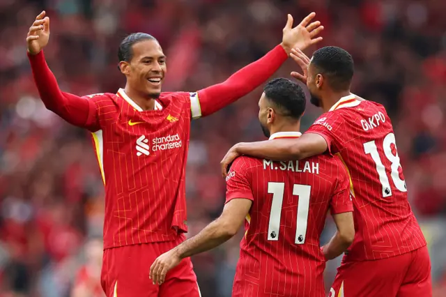Mohamed Salah of Liverpool celebrates scoring his team's first goal with teammates Virgil van Dijk and Cody Gakpo