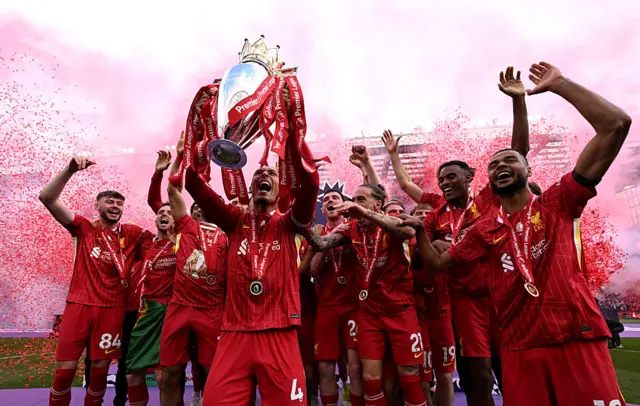 Virgil van Dijk lifting the Premier League trophy