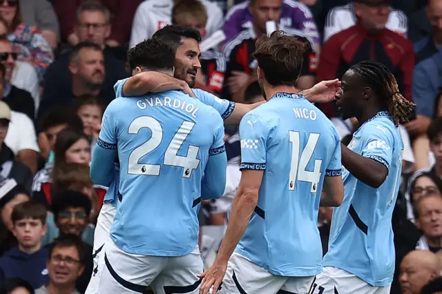 Manchester City's German midfielder #19 Ilkay Gundogan (2L) celebrates with teammates