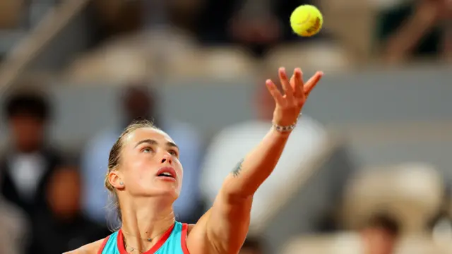 Aryna Sabalenka throws the ball to serve