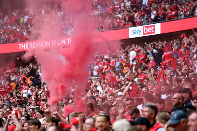 Charlton Athletic fans let off flares as they celebrate in the stands