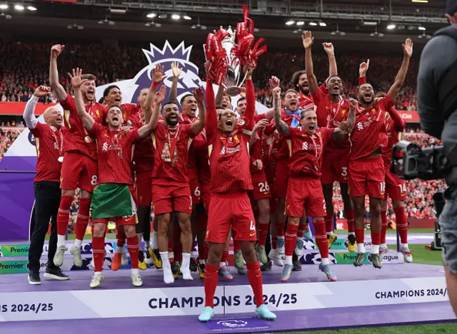 Virgil van Dijk of Liverpool, lifts the Premier League trophy