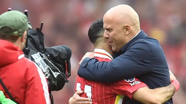 Arne Slot hugs Mo Salah