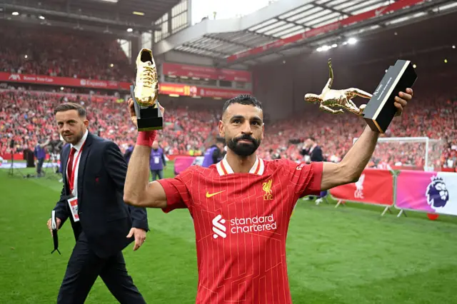 Salah holds aloft his Playmaker and Golden Boot awards