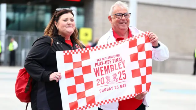 Leyton Orient fans holding up a Wembley 2025 flag