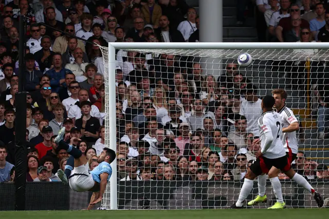 Manchester City's German midfielder #19 Ilkay Gundogan scores the opening goal with this acrobatic attempt