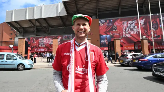 A Liverpool fan before the Premier League match at Anfield, Liverpool.