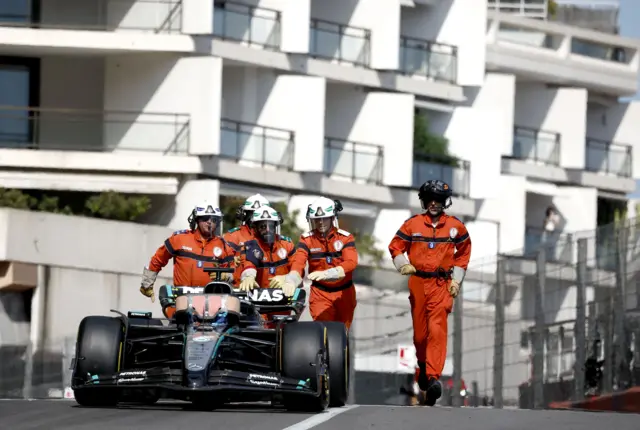 Marshals push George Russell's car back to the garage