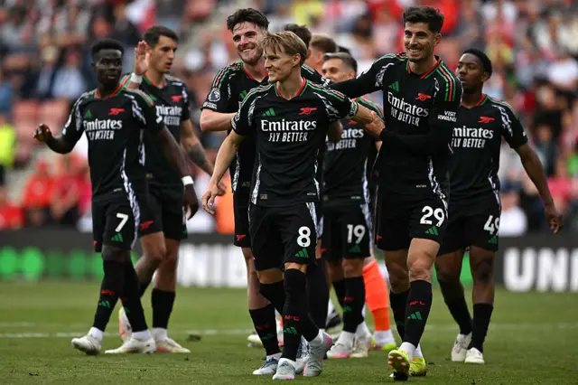 Arsenal's Norwegian midfielder #08 Martin Odegaard (C) celebrates with teammates after scoring his team's second goal