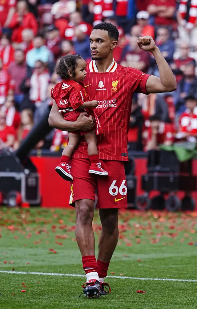 Trent holds a child in his arms