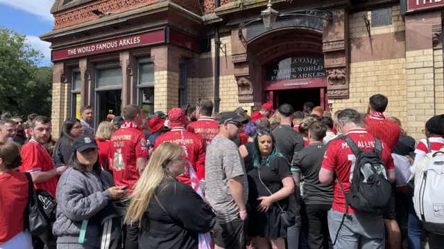 A crowd outside a pub