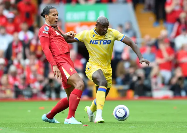 Virgil van Dijk (R) of Liverpool in action against Jean-Philippe Mateta