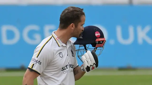Warwickshire's Sam Hain kissing his helmet in celebration