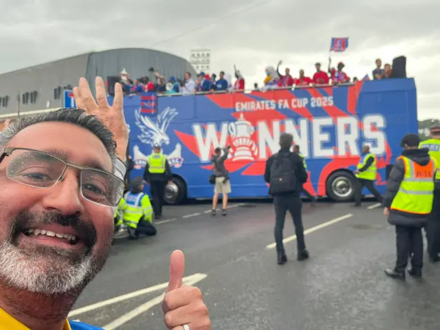 Crystal Palace fan in front of team bus