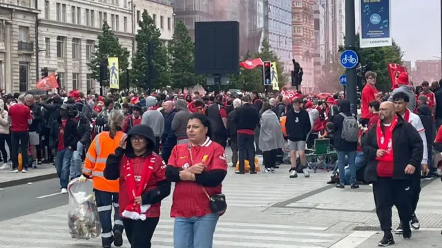 Crowd of people dressed in Liverpool shirts on The Strand in Liverpool