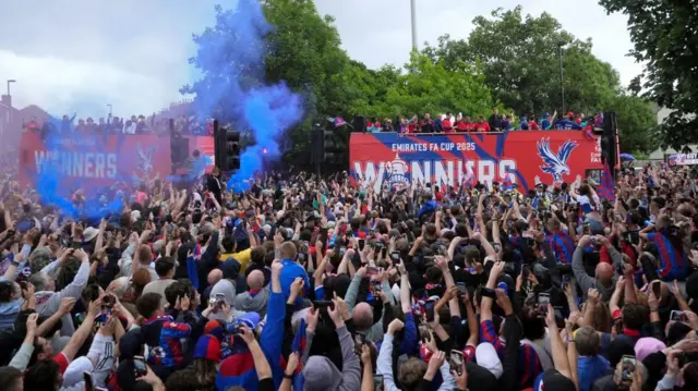 A crowd around a bus