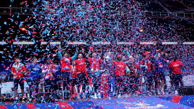 Loads of confetti falling in front of of the football team