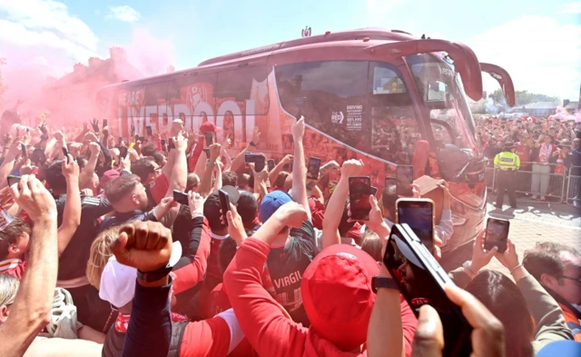 Liverpool fans welcome the team coach to Anfield