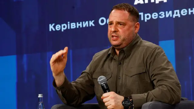 Andriy Yermak gestures as he speaks into a microphone