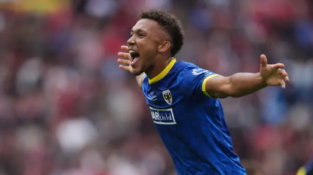 Isaac Ogundere celebrates for AFC Wimbledon