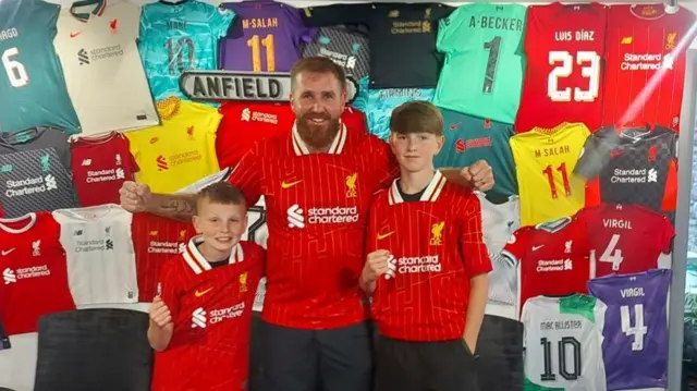 Flynn, Joe and Jaxson in Liverpool shirts before setting off