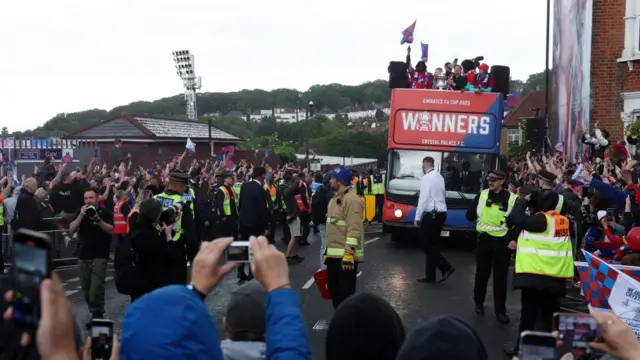 A crowd around a parked bus