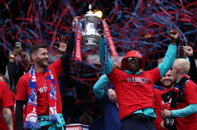 Crystal Palace's Joel Ward and Marc Guehi hold the trophy with teammates during the Victory celebrations after winning the FA Cup