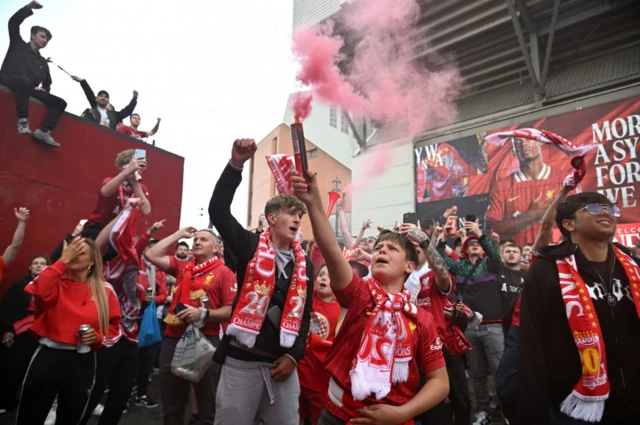 Liverpool supporters hold flares aloft