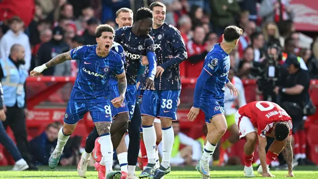 Chelsea's substitutes run onto the pitch to celebrate