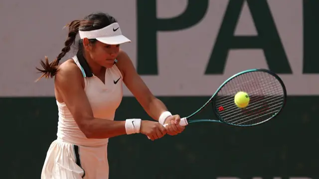 Emma Raducanu of Great Britain plays a backhand