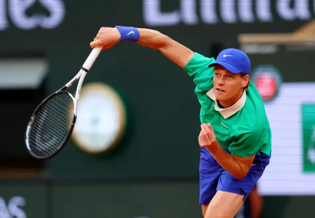 Jannik Sinner serves