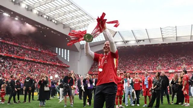 Arne Slot lifts Premier League trophy