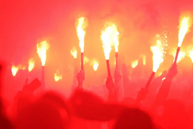 Palace fans held up flares as the trophy parade got closer towards Selhurst Park