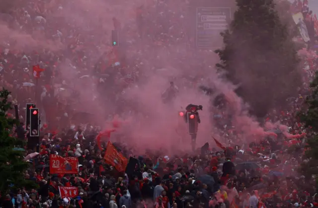 Fans on The Strand with red smoke