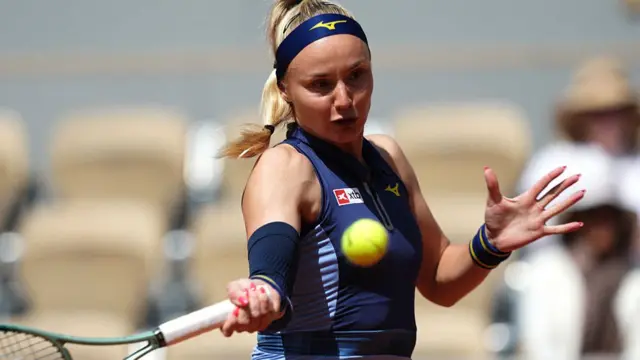 Slovakia's Rebecca Sramkova plays a forehand return