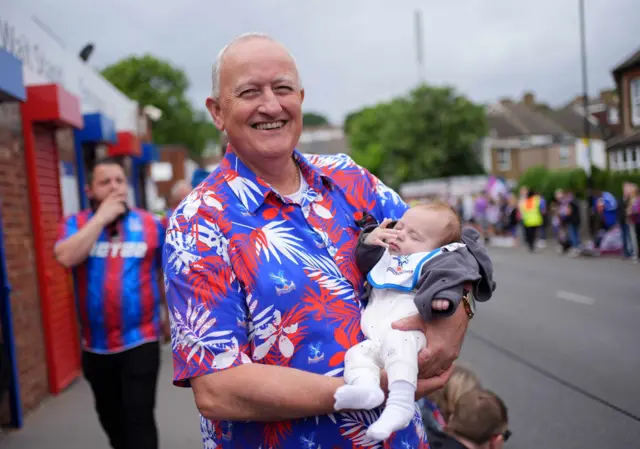 a man and baby pose for a photo